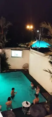 a group of people in a swimming pool at night at Hotel Mirasol in Jacó