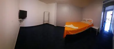 a bedroom with a bed and a television in it at Hotel Mirasol in Jacó
