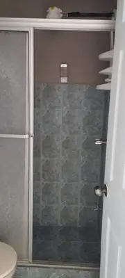 a shower with a glass door in a bathroom at Hotel Mirasol in Jacó