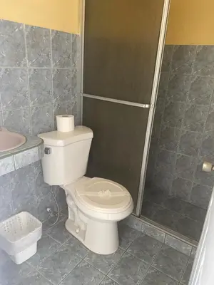 a bathroom with a toilet and a shower at Hotel Mirasol in Jacó