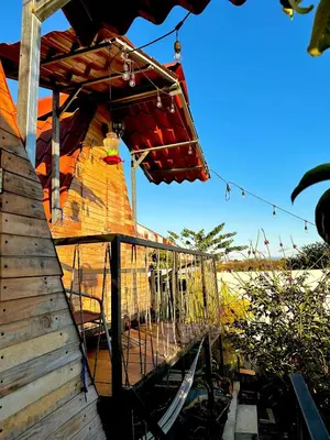 a balcony of a house with a swing at Airport Traveler's home. in Alajuela City