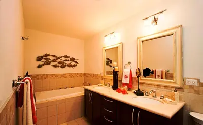 a bathroom with a sink and a tub and a mirror at Casa del Sol -Villas Catalinas in Potrero