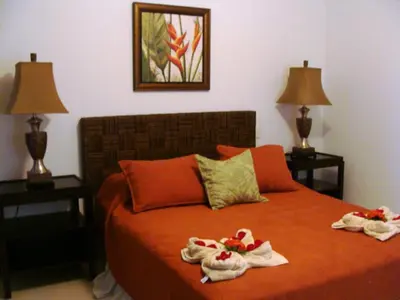 a bedroom with two towels on a bed with two lamps at Casa del Sol -Villas Catalinas in Potrero