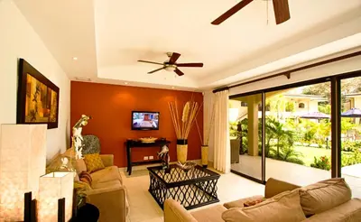 a living room with a couch and a ceiling fan at Casa del Sol -Villas Catalinas in Potrero