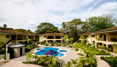 an exterior view of a resort with a swimming pool at Casa del Sol -Villas Catalinas in Potrero