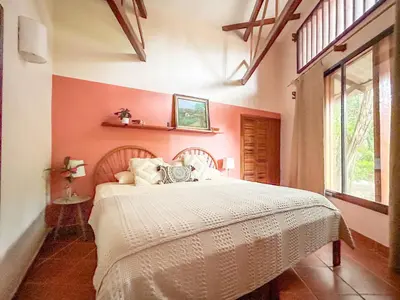a bedroom with a bed with a white bedspread at Fenix Hotel - On the Beach in Sámara