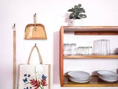 a shelf with plates and a tote bag at Fenix Hotel - On the Beach in Sámara