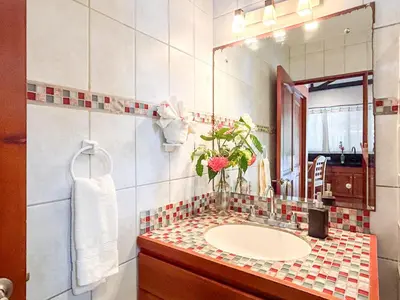 a bathroom with a sink and a mirror at Fenix Hotel - On the Beach in Sámara