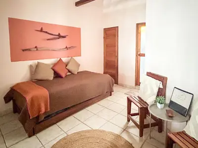a bedroom with a bed with two planes on the wall at Fenix Hotel - On the Beach in Sámara