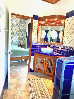 a bathroom with a sink and a mirror at Casa Maiana in Sámara