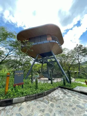 a large bench in a park with a sign at Suitree Experience Hotel in Guanacaste
