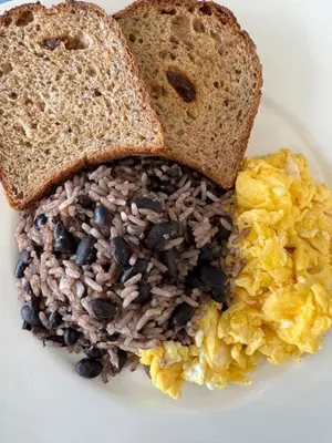 a plate of breakfast food with toast and eggs at Hotel Cacts in San José