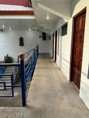 a hallway of a school building with a door at Hotel Cacts in San José