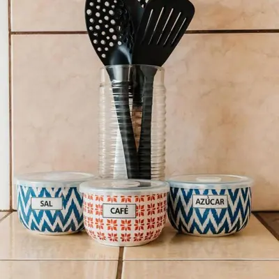 three containers with utensils in them sitting on a counter at Casa Cafetal Aeropuerto in Alajuela City