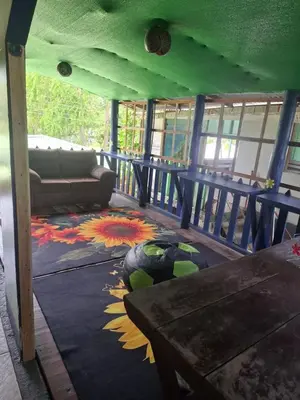 a living room with a couch and a colorful rug at Cabinas Tortuguero Natural in Tortuguero