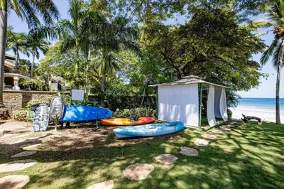 a group of kayaks on the grass near the beach at Palms 23 Luxury Beachfront Villa in Playa Flamingo