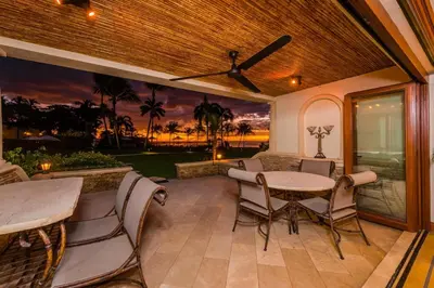 an outdoor patio with a table and chairs at Palms 23 Luxury Beachfront Villa in Playa Flamingo