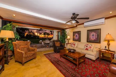 a living room with a couch and a table at Palms 23 Luxury Beachfront Villa in Playa Flamingo