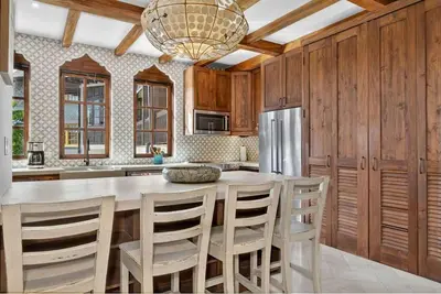 a kitchen with a table and chairs and a refrigerator at Plaza Carlota 22 At Las Catalinas in Playa Danta