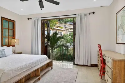 a bedroom with a bed and a sliding glass door at Plaza Carlota 22 At Las Catalinas in Playa Danta