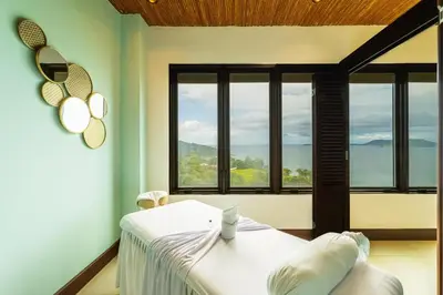 a bedroom with a bed and large windows at 360 Splendor 105A-Ocean View 2 Br Condo-Breakfast Included! in Playa Flamingo