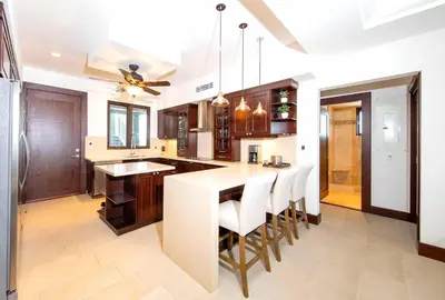 a kitchen with a large island with white counter tops at 360 Splendor 105A-Ocean View 2 Br Condo-Breakfast Included! in Playa Flamingo