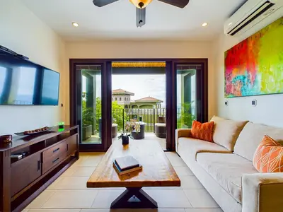 a living room with a couch and a tv at 360 Splendor 403 Ocean View Condo- With Breakfast in Playa Flamingo