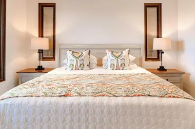 a bedroom with a large bed with two lamps at 360 Splendor 403 Ocean View Condo- With Breakfast in Playa Flamingo