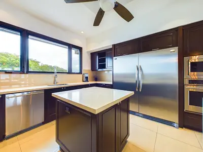 a large kitchen with a stainless steel refrigerator at 360 Splendor 307F Ocean View 3Br Breakfast in Playa Flamingo