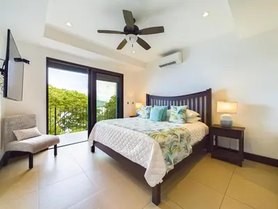 a bedroom with a bed and a ceiling fan at 360 Splendor 307F Ocean View 3Br Breakfast in Playa Flamingo