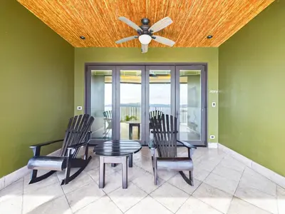 a dining room with a ceiling fan and a table and chairs at 360 Splendor 307F Ocean View 3Br Breakfast in Playa Flamingo