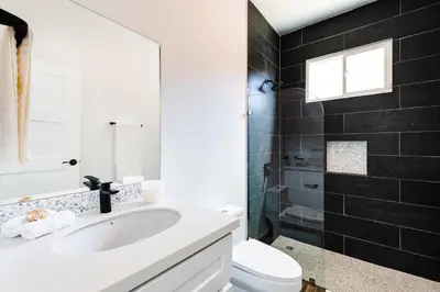 a white bathroom with a sink and a toilet at Casa Serena - Ocean View 3 Br House in Brasilito