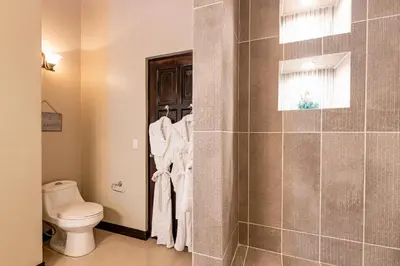 a bathroom with a toilet and a shower at Palms 26 Sueños Del Sol in Playa Flamingo