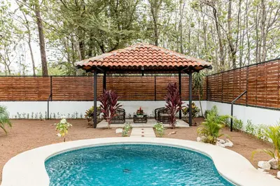 a swimming pool in a yard with a gazebo at Flamingo Estates 18- 4 Br House With Pool in Brasilito