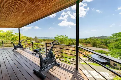 a gym with two exercise bikes on a wooden deck at The Haven-Mar Vista 2 Br House With Pool And 1 Br Casita in Brasilito