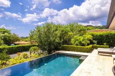a swimming pool in the middle of a garden at The Haven-Mar Vista 2 Br House With Pool And 1 Br Casita in Brasilito