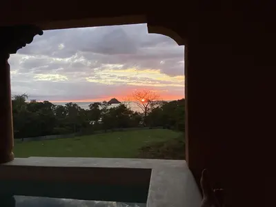 a view of the sunset from a room with a window at Plaza Mercado 20 At Las Catalinas in Playa Danta