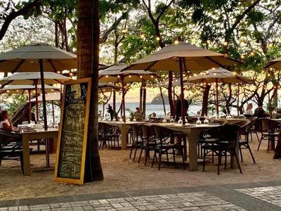 a group of tables and chairs with umbrellas at Plaza Mercado 20 At Las Catalinas in Playa Danta