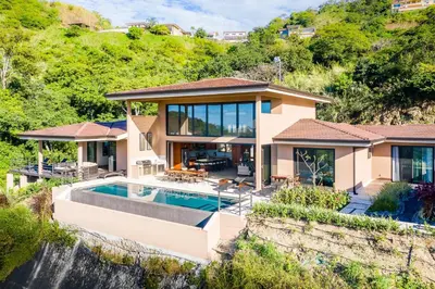 a house with a swimming pool and a waterfall at Casa Vistas At Mar Vista in Brasilito