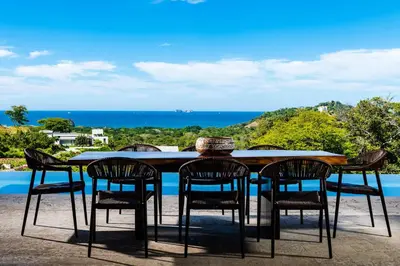 a table and chairs with a view of the ocean at Casa Vistas At Mar Vista in Brasilito