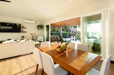 a dining room with a wooden table and chairs at Casa Natura- 3 Bedroom Ocean View Home At Mar Vista in Brasilito