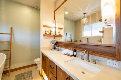 a bathroom with two sinks and a mirror at Casa Natura- 3 Bedroom Ocean View Home At Mar Vista in Brasilito