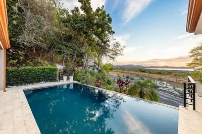 a swimming pool in the backyard of a house at Casa Natura- 3 Bedroom Ocean View Home At Mar Vista in Brasilito