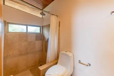 a bathroom with a toilet and a shower at Casa Brisas Del Mar- Luxury 6 Bedroom Ocean View Home in Puerto Viejo