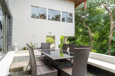 an outdoor patio with a table and chairs at Casa Brisas Del Mar- Luxury 6 Bedroom Ocean View Home in Puerto Viejo