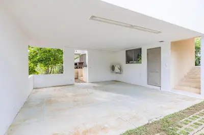 an empty living room with white walls and concrete floors at Casa Brisas Del Mar- Luxury 6 Bedroom Ocean View Home in Puerto Viejo