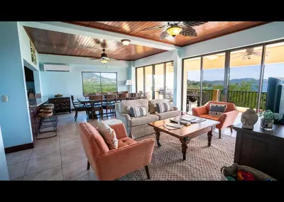 a large living room with couches and a table at Presidential Suites 15-Oceanview Condo in Playa Flamingo