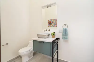 a bathroom with a toilet and a sink at Casa Sunset At Mar Vista in Playa Flamingo
