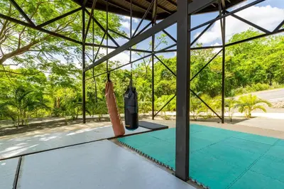 two baseball bats on the floor of a pavilion at Casa Sunset At Mar Vista in Playa Flamingo