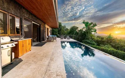 a swimming pool in the middle of a house at Casa Sunset At Mar Vista in Playa Flamingo